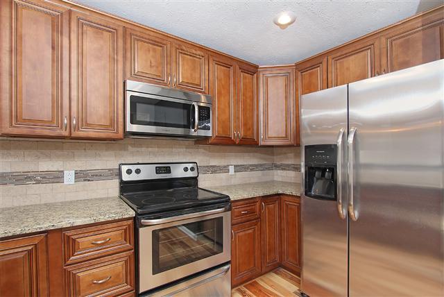 Kitchen has new cabinets, granite, back splash, appliances and more.