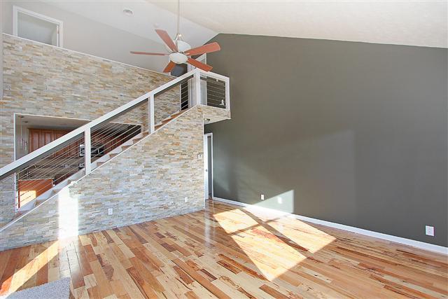 Large living room/great room with soaring ceilings and the home has new paint throughout.