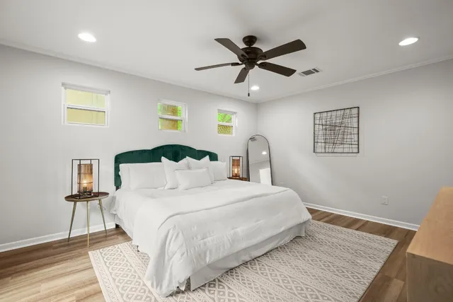 a bedroom with a large bed and a chandelier