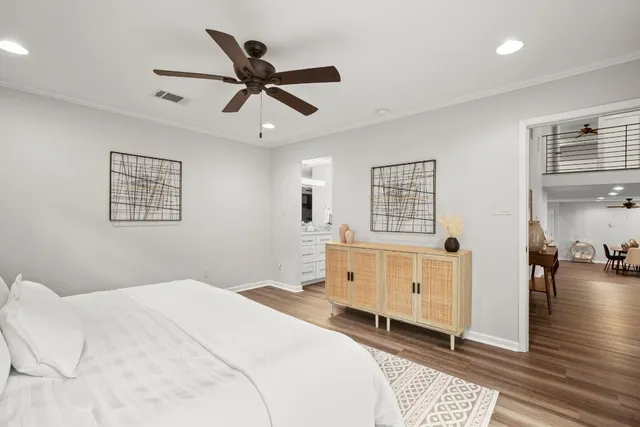a bedroom with a large bed and a chandelier