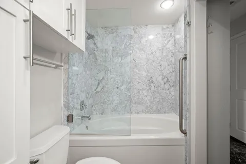 a bathroom with a bathtub and a shower