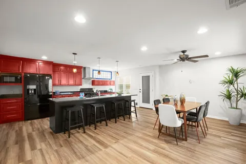 a view of a dining room with furniture and wooden floor