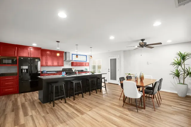 a view of a dining room with furniture and wooden floor