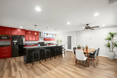 a view of a dining room with furniture and wooden floor