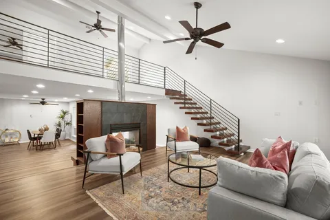 a living room with furniture and a ceiling fan