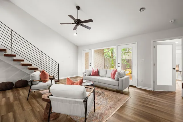 a living room with furniture and a chandelier