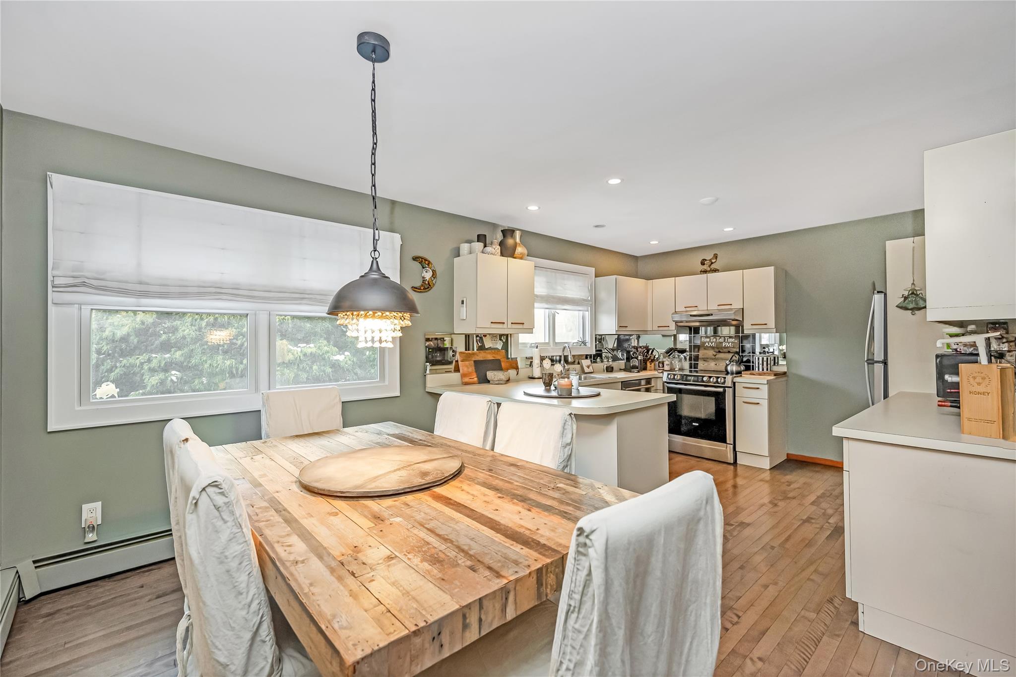 2 Martin Place Northport, NY 11768 - Photo 13 of 24 a kitchen with kitchen island a stove a refrigerator a sink dishwasher with a dining table and chairs