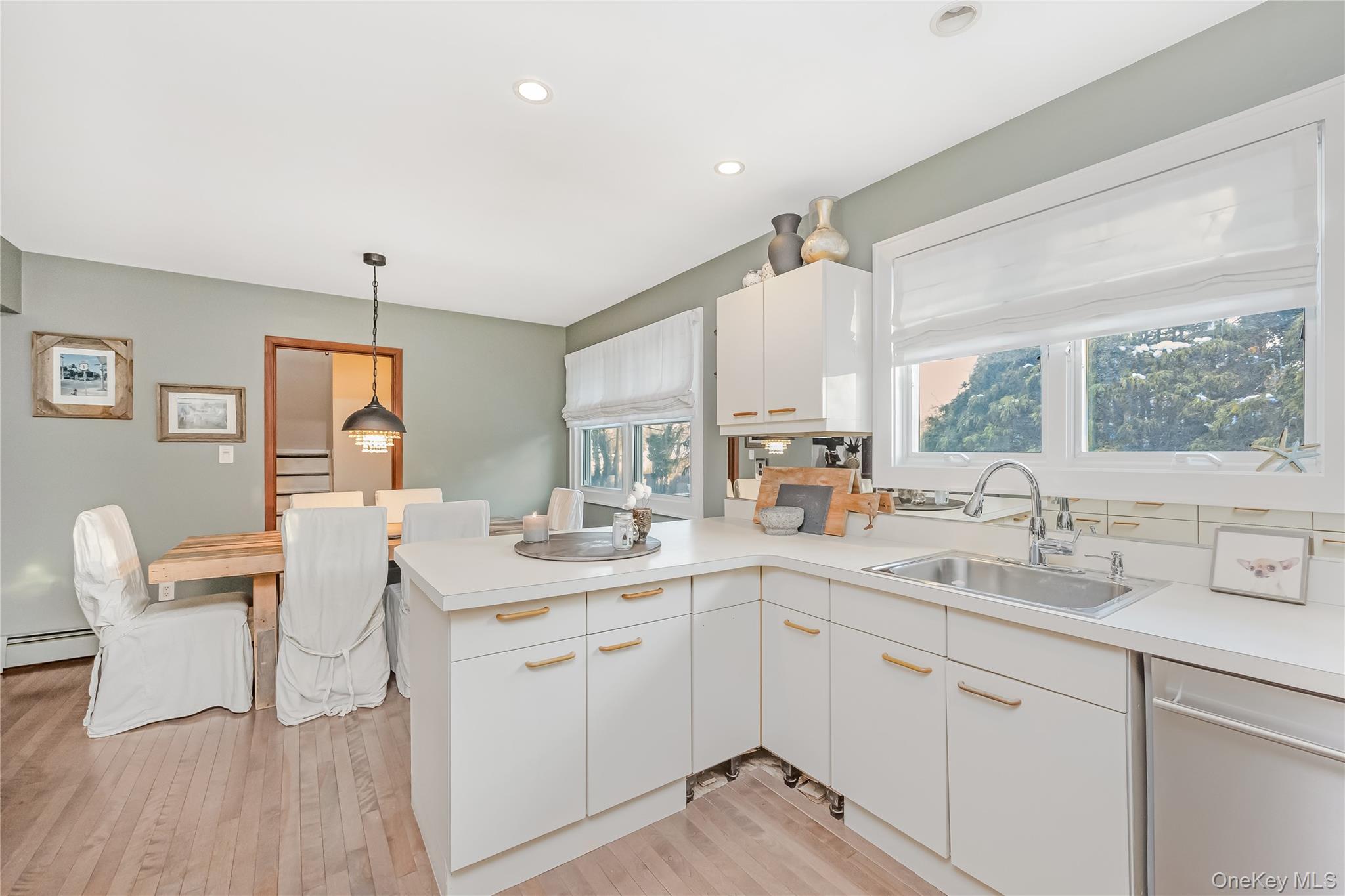 2 Martin Place Northport, NY 11768 - Photo 16 of 24 a kitchen with a sink cabinets and wooden floor