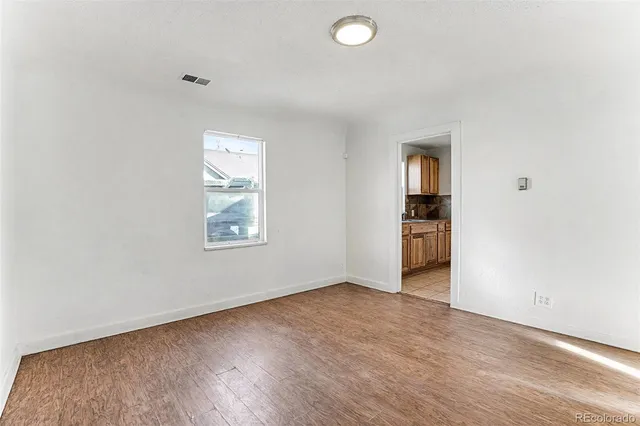 an empty room with closet and windows