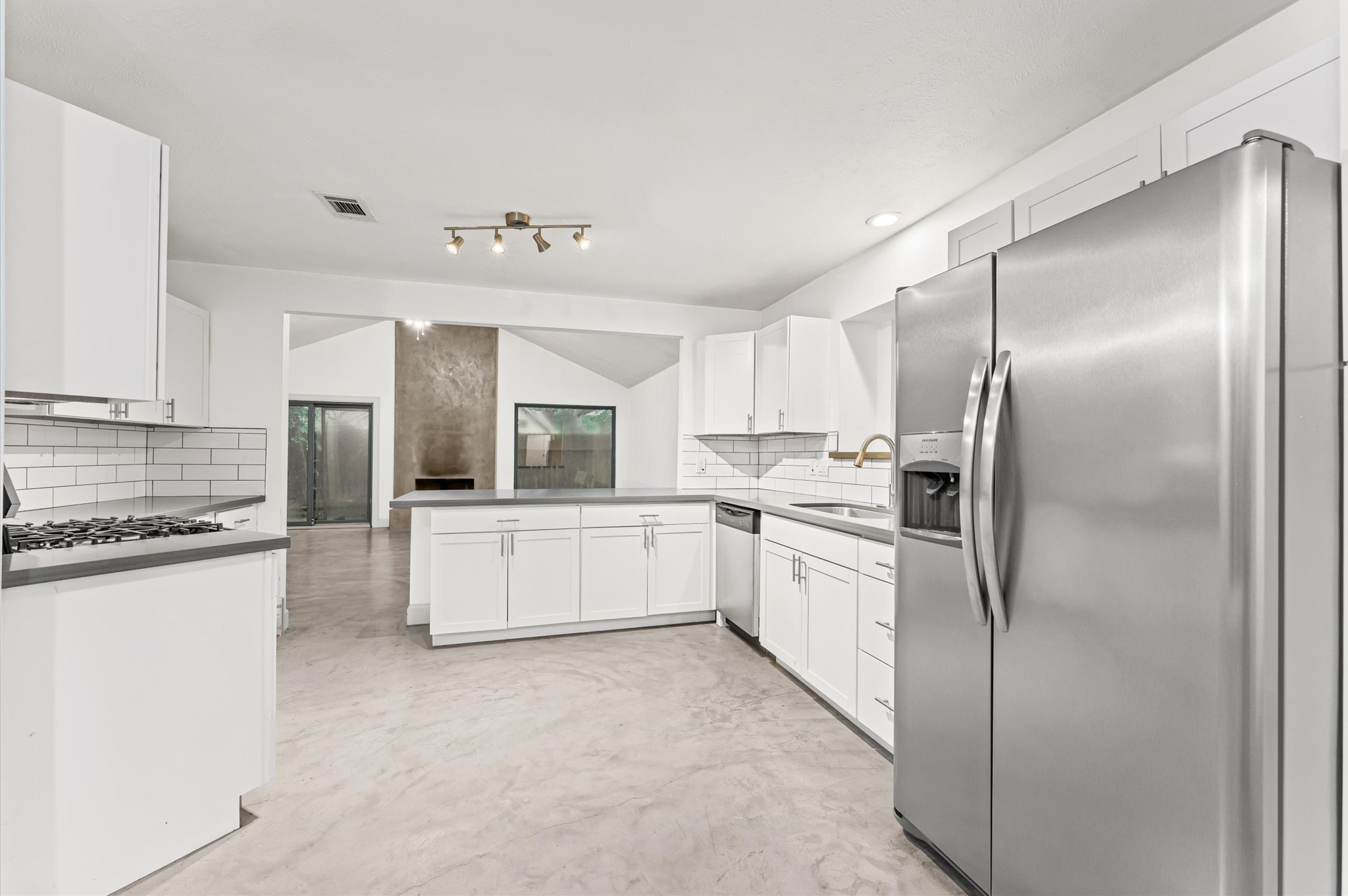 29 South High Oaks Circle Spring, TX 77380 - Photo 5 of 21 a large white kitchen with cabinets a sink and stainless steel appliances