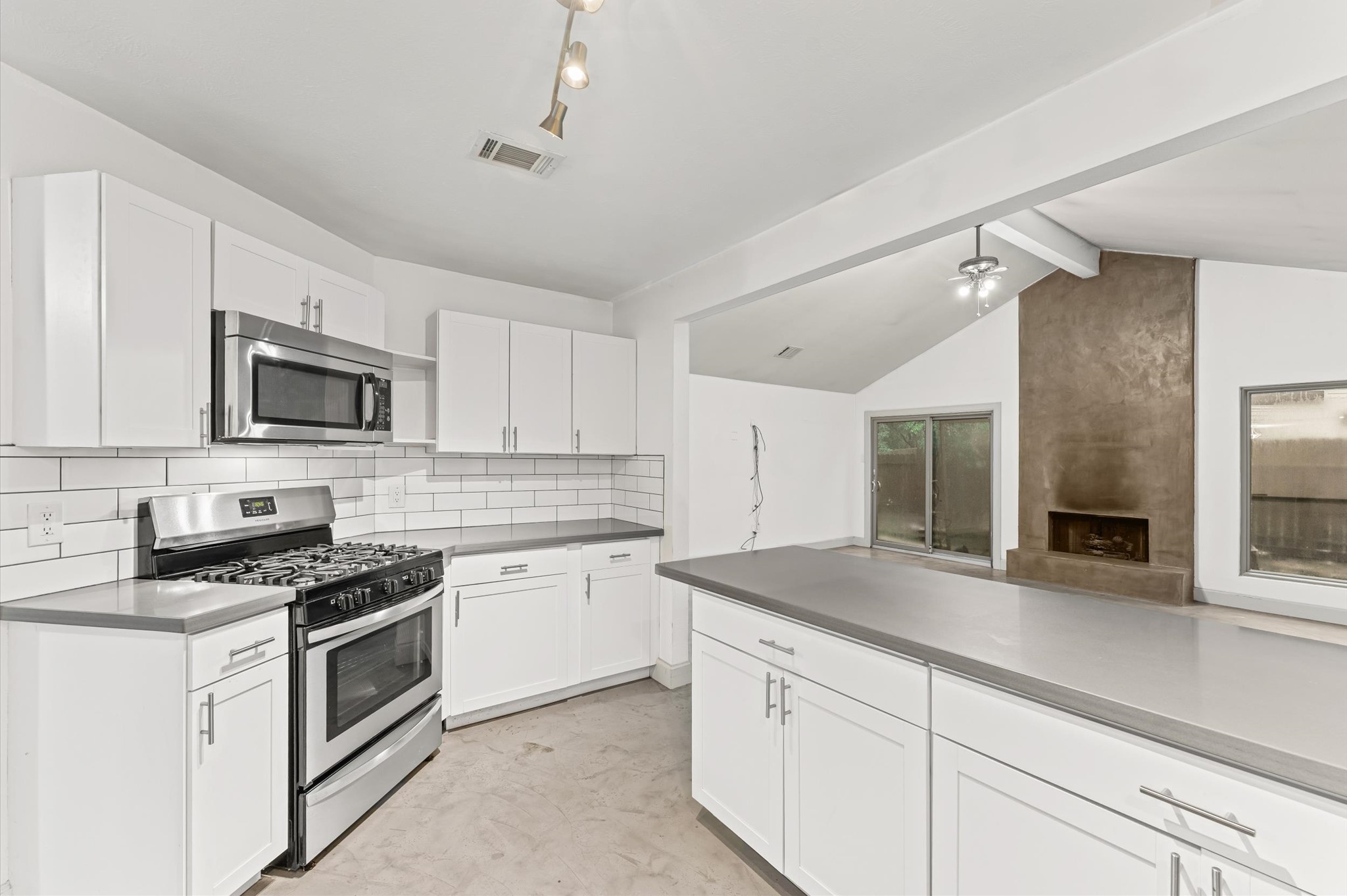 29 South High Oaks Circle Spring, TX 77380 - Photo 6 of 21 a kitchen with granite countertop white cabinets and white appliances