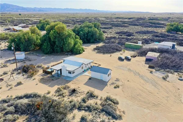 an aerial view of a house with a yard