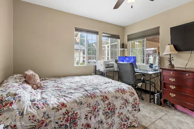 a view of a porch with chairs and backyard of a house