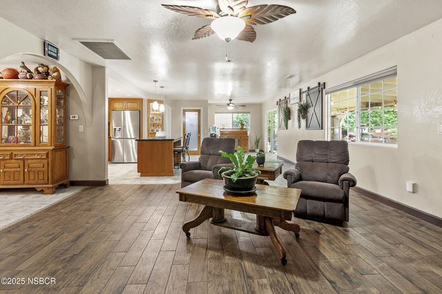 a view of a livingroom with furniture window and wooden floor