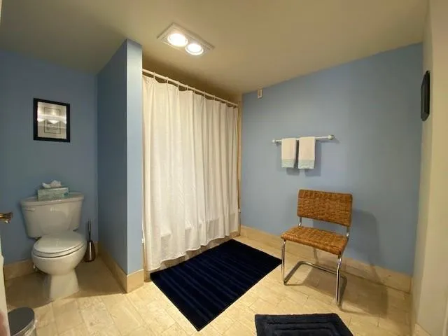 a bedroom with two beds and a large window