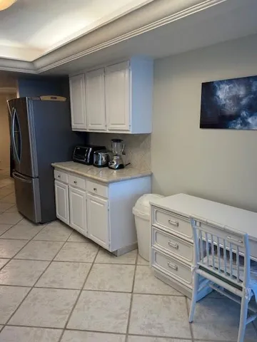 a kitchen with stainless steel appliances a cabinets and a refrigerator