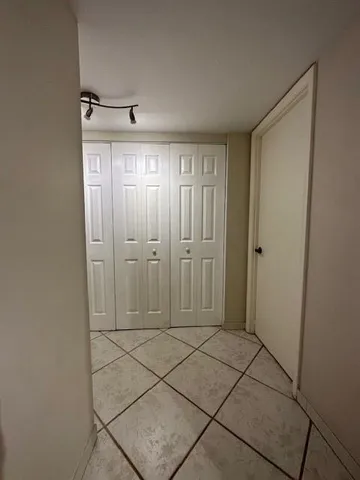 a living room with furniture and a lamp