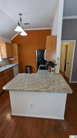 a kitchen with stainless steel appliances granite countertop a refrigerator a stove and a sink