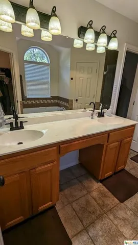 a spacious bathroom with a sink vanity and mirror