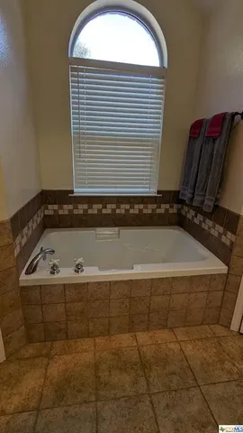 a view of a hallway with wooden floor and closet