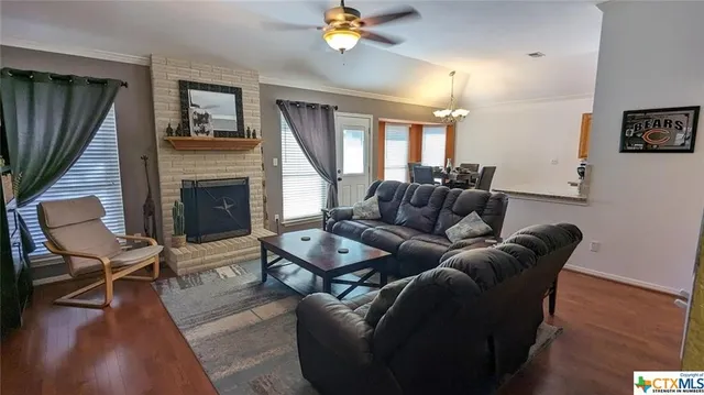 a living room with furniture a fireplace and a window