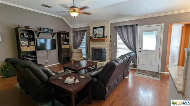 a living room with furniture a window and a fireplace