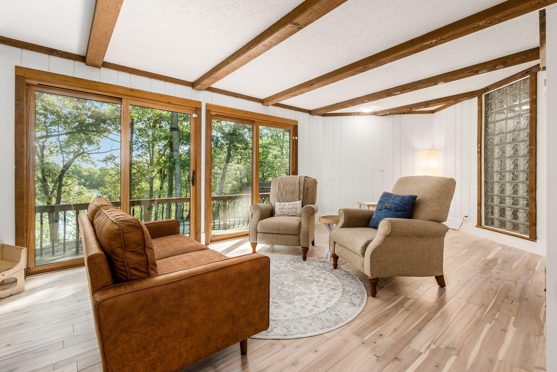4610 Red Bank Road Galena, OH 43021 - Photo 30 of 88 Sitting room with beams, two doors to deck, and hardwood floors measures 11’9” x 28’5”