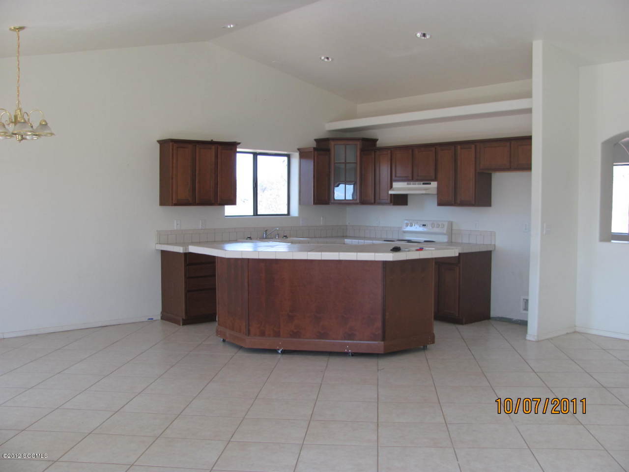 1642 Tisu Court Rio Rico, AZ 85648 - Photo 3 of 3 a kitchen with kitchen island granite countertop a sink a counter top space and cabinets