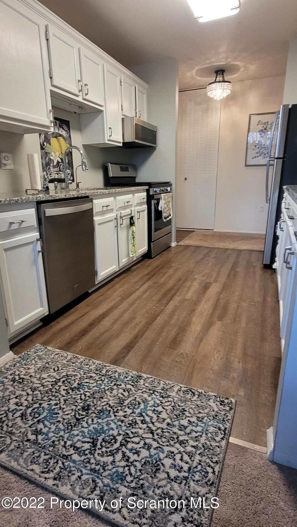 1506 Summit Pointe Scranton, PA 18508 - Photo 12 of 21 a kitchen with stainless steel appliances granite countertop a sink stove and refrigerator