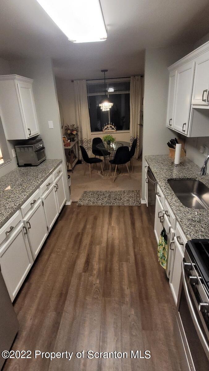 1506 Summit Pointe Scranton, PA 18508 - Photo 4 of 21 a kitchen with granite countertop a stove and a sink