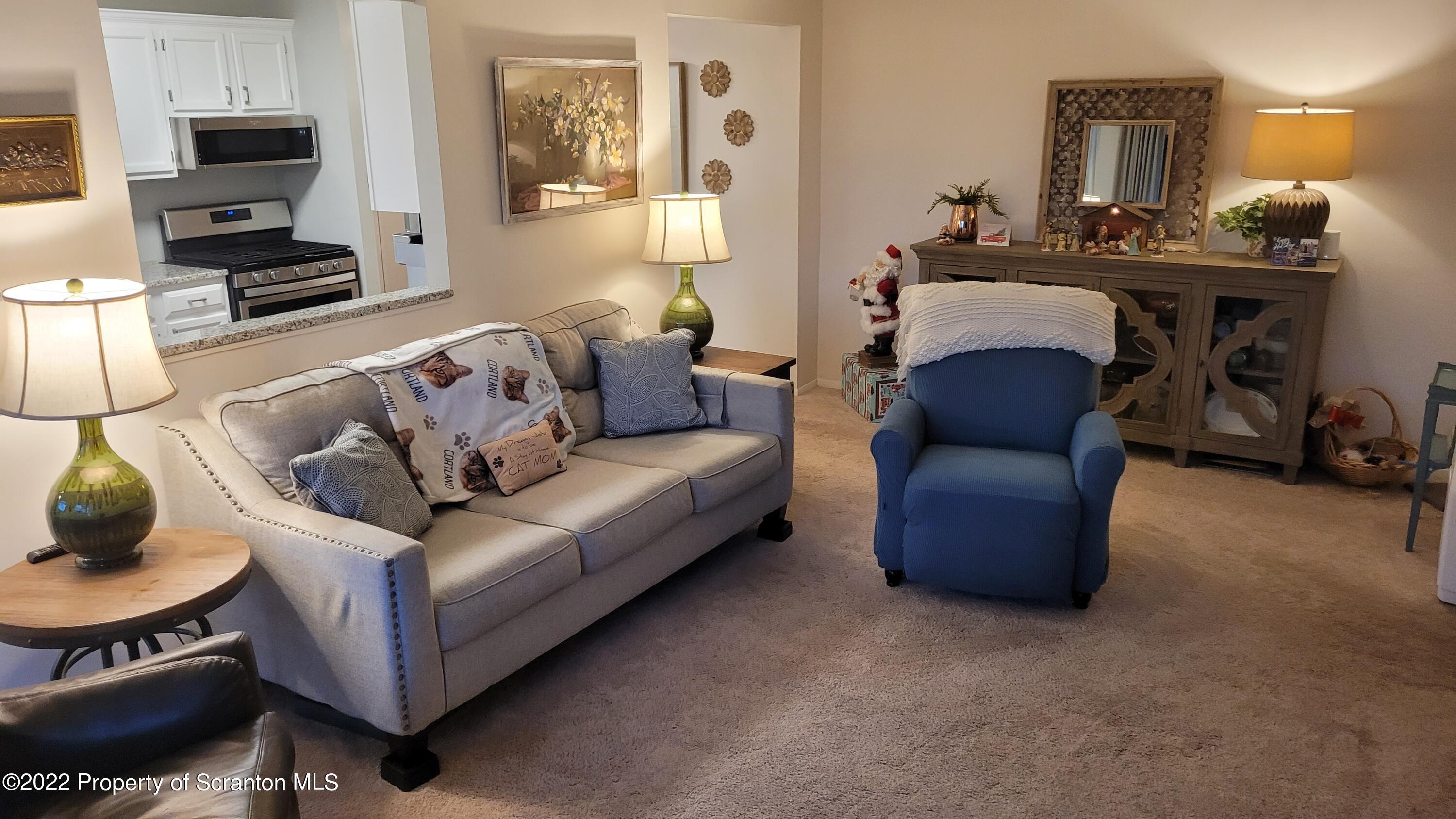 1506 Summit Pointe Scranton, PA 18508 - Photo 8 of 21 a living room with furniture a flat screen tv and kitchen view