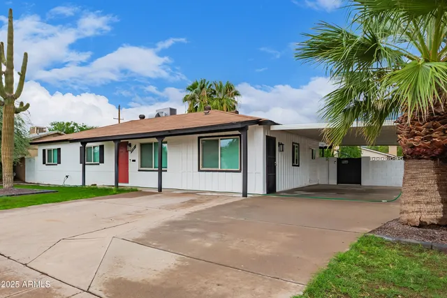 a front view of a house with a garden and entryway