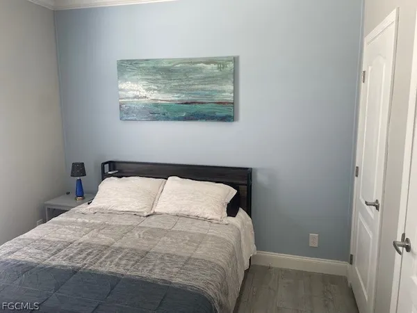 a bedroom with a bed and wall painting