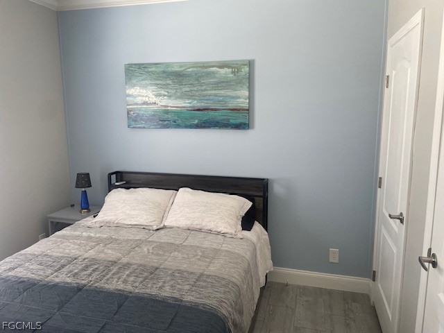 2951 York Road St. James City, FL 33956 - Photo 11 of 17 a bedroom with a bed and wall painting
