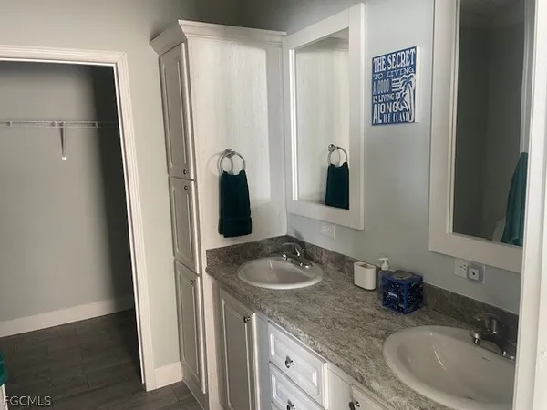 a bathroom with a granite countertop sink and a mirror