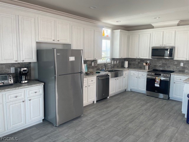 2951 York Road St. James City, FL 33956 - Photo 6 of 17 a kitchen with cabinets stainless steel appliances and a window
