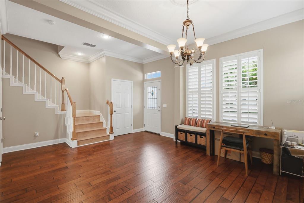 907 Pawstand Road Celebration, FL 34747 - Photo 8 of 49 a view of a livingroom with hardwood floor and workspace