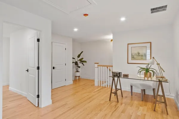 a view of a room with wooden floor and windows