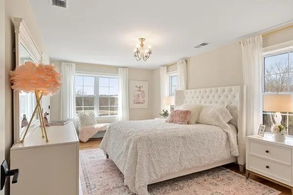 a bedroom with a large bed and a window