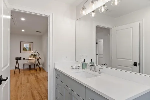 a en suite bathroom with a sink and a mirror