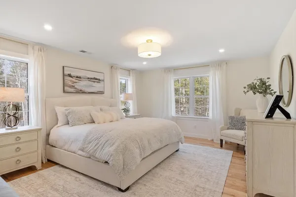 a bedroom with a large bed and a window