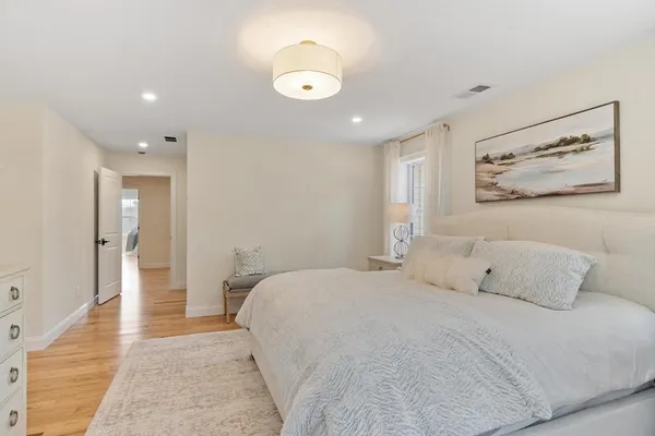 a bedroom with a bed and a large mirror