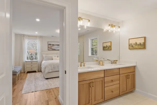 a en suite bathroom with a double vanity sink a mirror and a