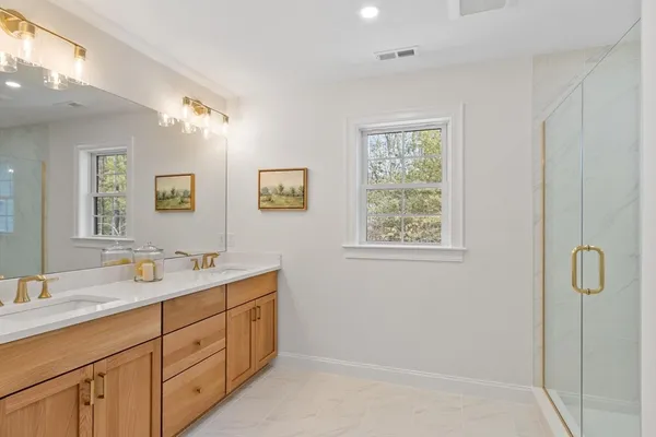 a spacious bathroom with 2 sink tub and shower