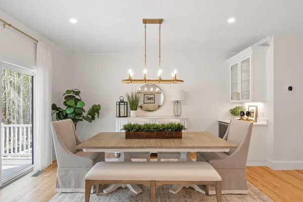 a view of a dining room with furniture window and wooden floor
