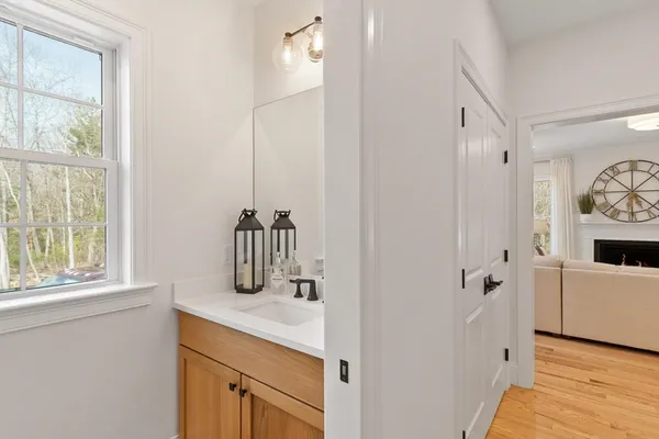 a kitchen with white cabinets and window
