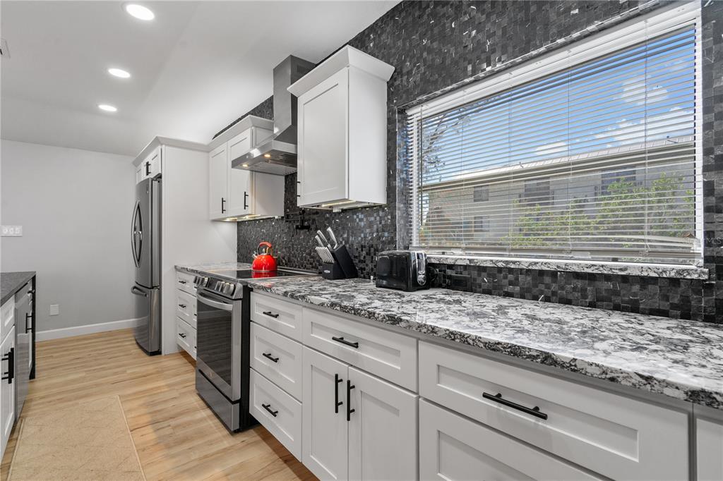 2476 North Beach Road Englewood, FL 34223 - Photo 15 of 58 a kitchen with a sink stove and refrigerator