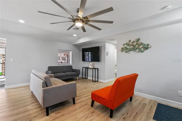 a living room with furniture white walls and a fireplace