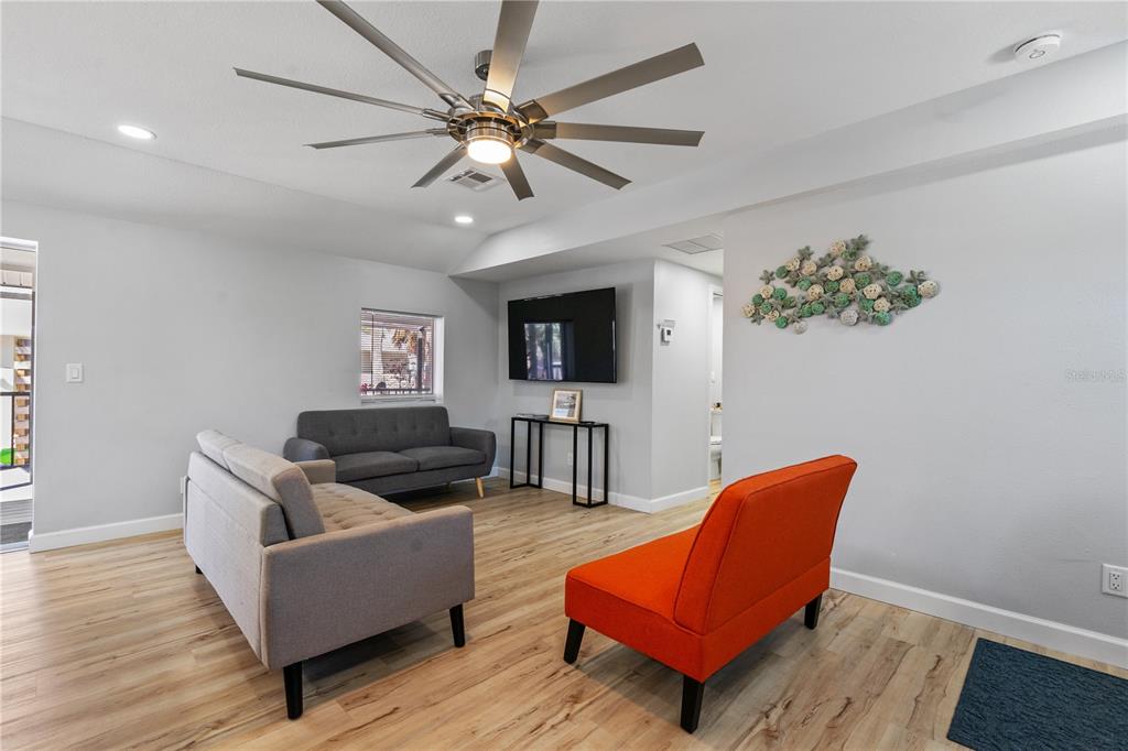 2476 North Beach Road Englewood, FL 34223 - Photo 19 of 58 a living room with furniture and a flat screen tv