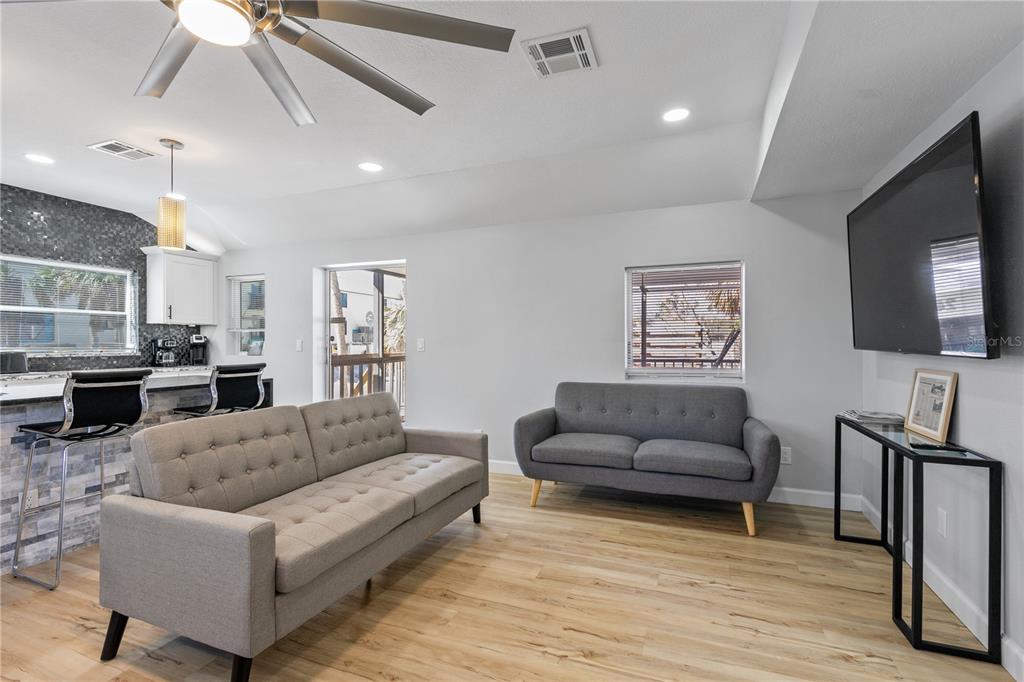 2476 North Beach Road Englewood, FL 34223 - Photo 20 of 58 a living room with furniture and a flat screen tv